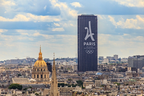 Modern skyscraper with paris logo overlooks city